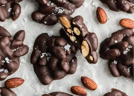 Delicious chocolate covered almond clusters for a sweet and crunchy snack.