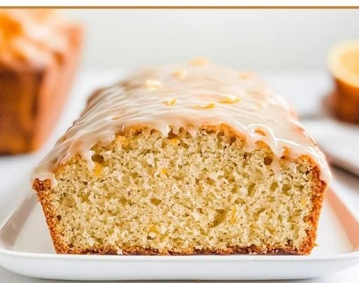 A sliced loaf of gluten-free orange cardamom bread decorated with orange zest.