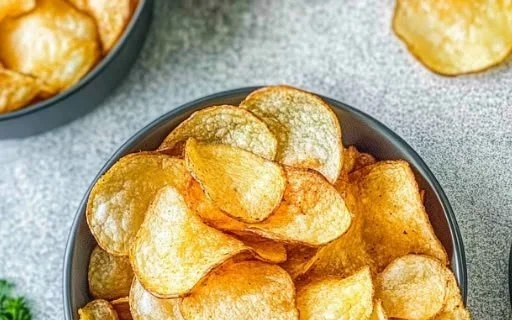 Crispy homemade air fryer potato chips in a bowl