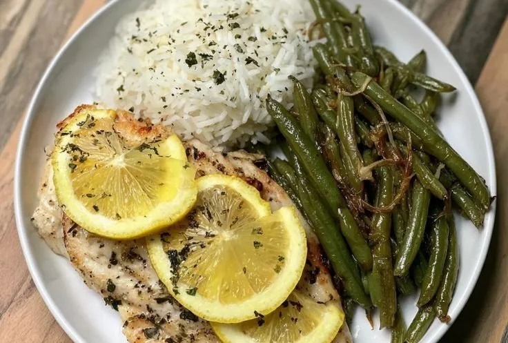 Plate of Lemon Garlic Butter Tilapia drizzled with lemon and garlic sauce.