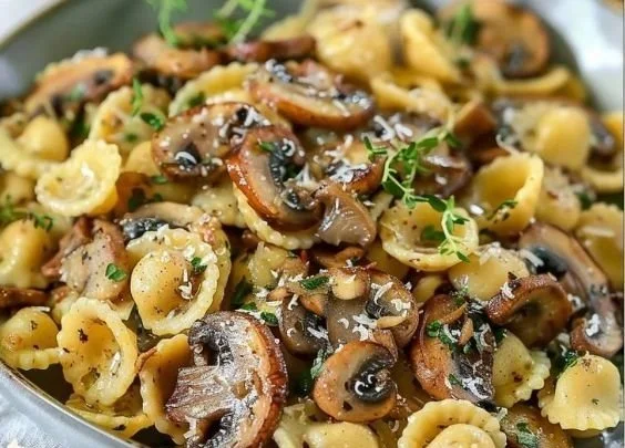 Dish of orecchiette pasta served with creamy mushroom thyme sauce