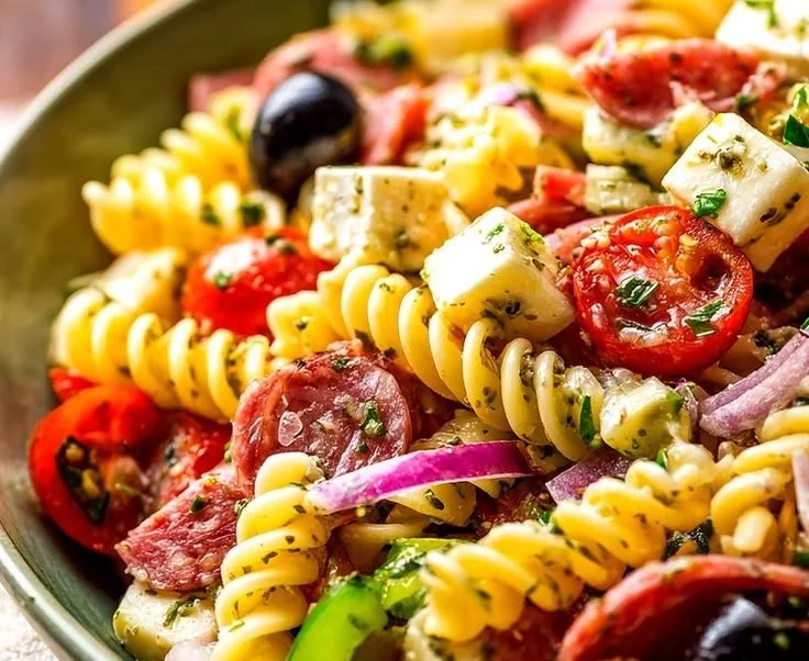 A vibrant bowl of perfect Italian Pasta Salad with fresh vegetables and herbs
