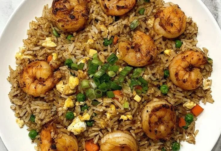 Plate of delicious shrimp fried rice with colorful vegetables