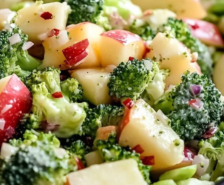 Delicious Apple Broccoli Salad with apples, broccoli, and nuts in a bowl
