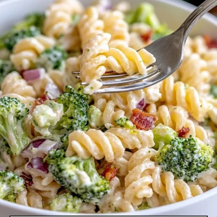 Delicious broccoli pasta salad with fresh vegetables and dressing