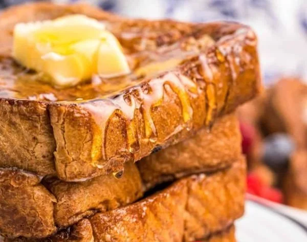 Delicious Blackstone French Toast served with syrup and berries