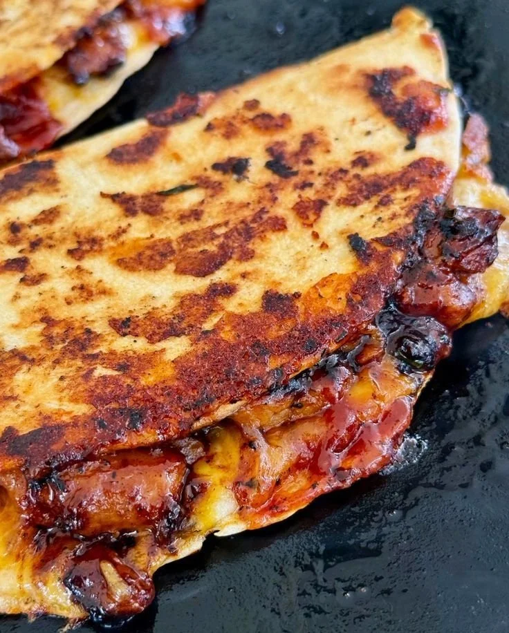 Blackstone Hot Honey BBQ Chicken Quesadillas served on a plate with toppings