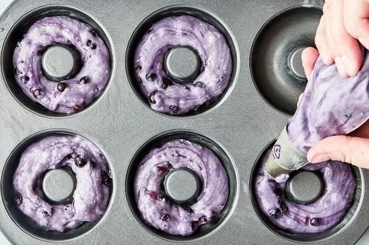 Freshly baked blueberry cake donuts with blueberries on top