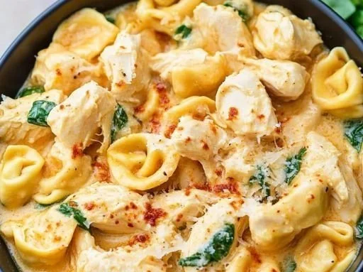 Cozy crockpot chicken tortellini dish ready to serve on a weeknight dinner