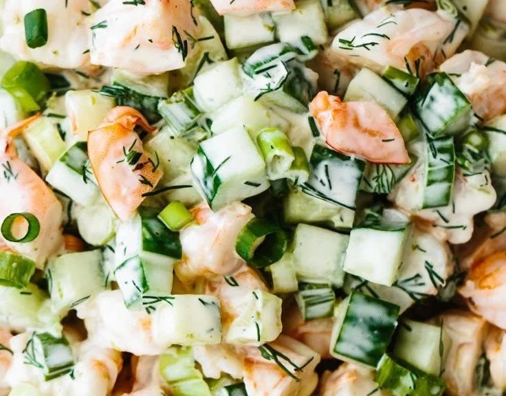 Delicious healthy cucumber shrimp salad topped with fresh herbs and lime