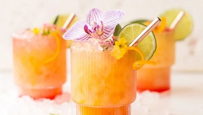 Pineapple Mango Rum Punch served in a tropical setting with fresh fruit garnish.
