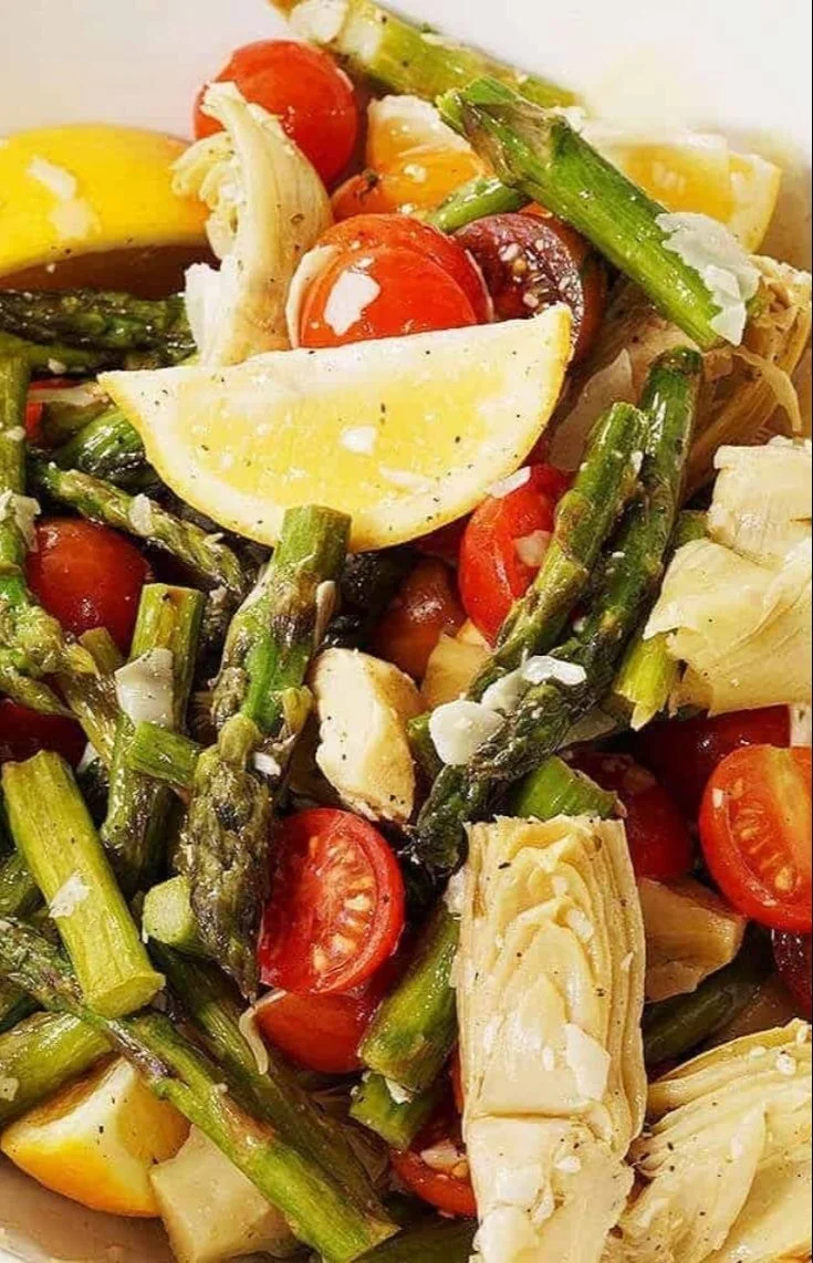 A vibrant Asparagus Cherry Tomato Salad garnished with fresh herbs.