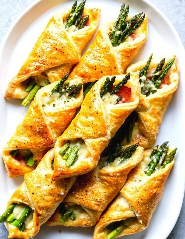Fresh asparagus wrapped in flaky puff pastry bundles