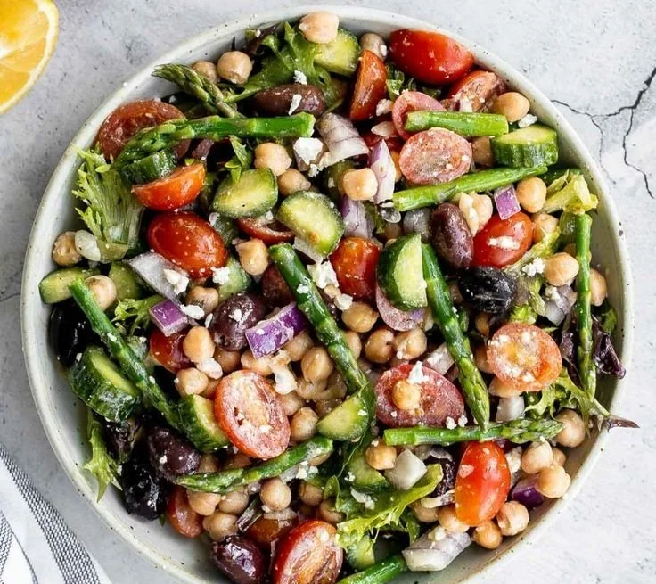 Chopped asparagus salad with fresh vegetables for a healthy meal.