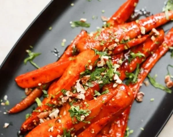 Oven roasted carrots glazed with gochujang sauce for a spicy flavor.