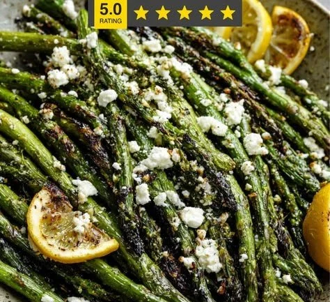 Lemon Feta Grilled Asparagus dish garnished with lemon slices and feta cheese
