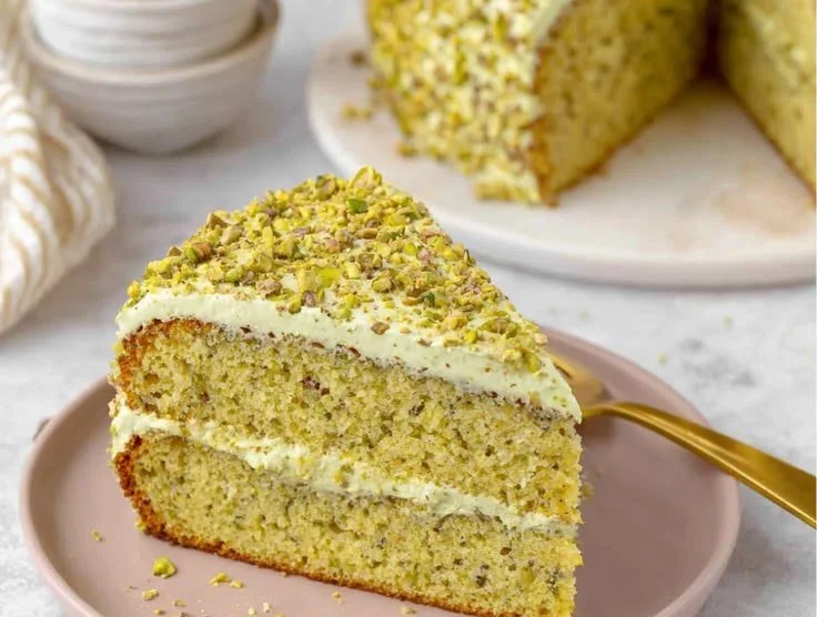 Deliciously baked pistachio cake with a rich green color and creamy frosting