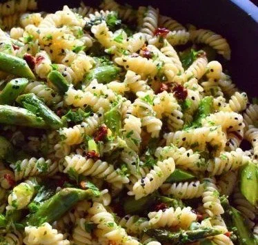 A bowl of Roasted Asparagus Lemon Butter Pasta Salad with vibrant vegetables