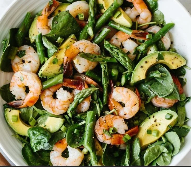 Delicious shrimp salad with asparagus and avocado garnished fresh ingredients