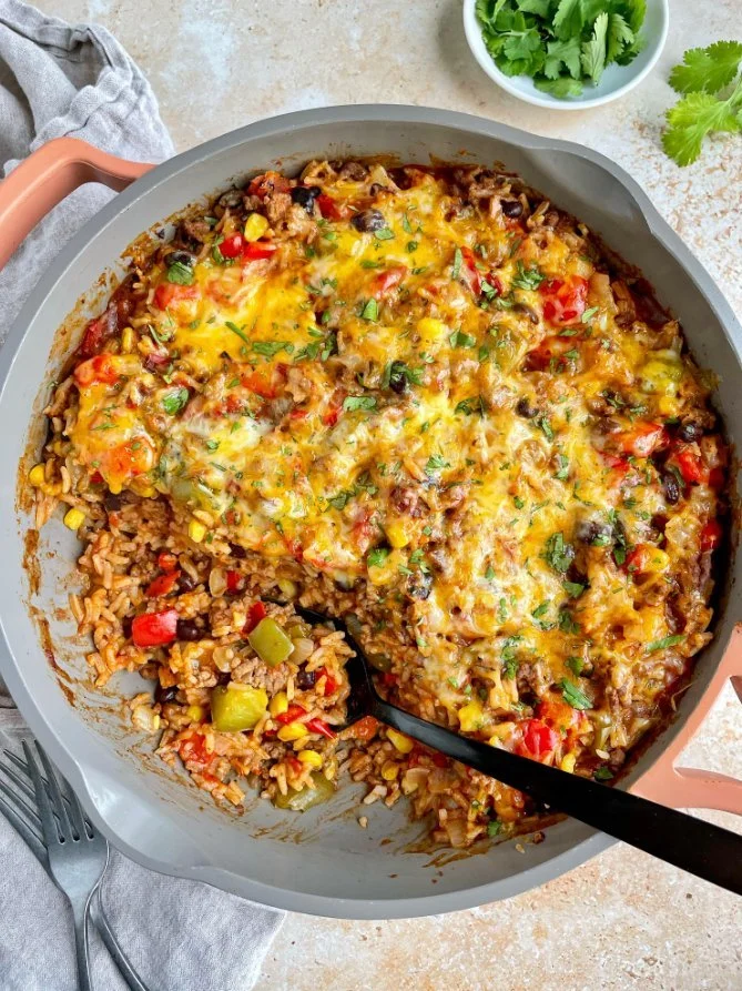 A colorful unstuffed pepper skillet with rice, ground meat, and spices in a pan.