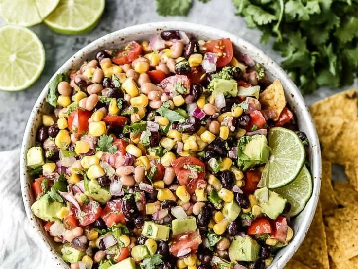 Bowl of colorful Cowboy Caviar salad made with beans, peppers, and spices.