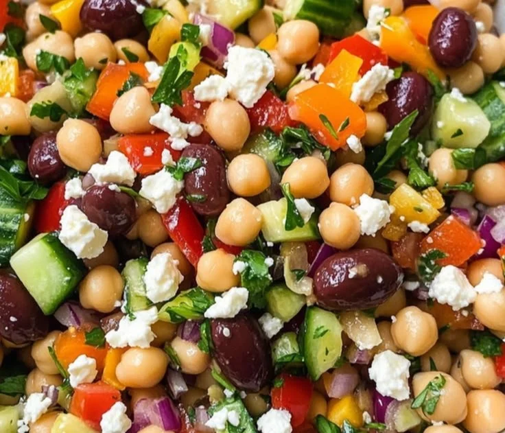 A colorful and nutritious dense bean salad with various beans and fresh vegetables