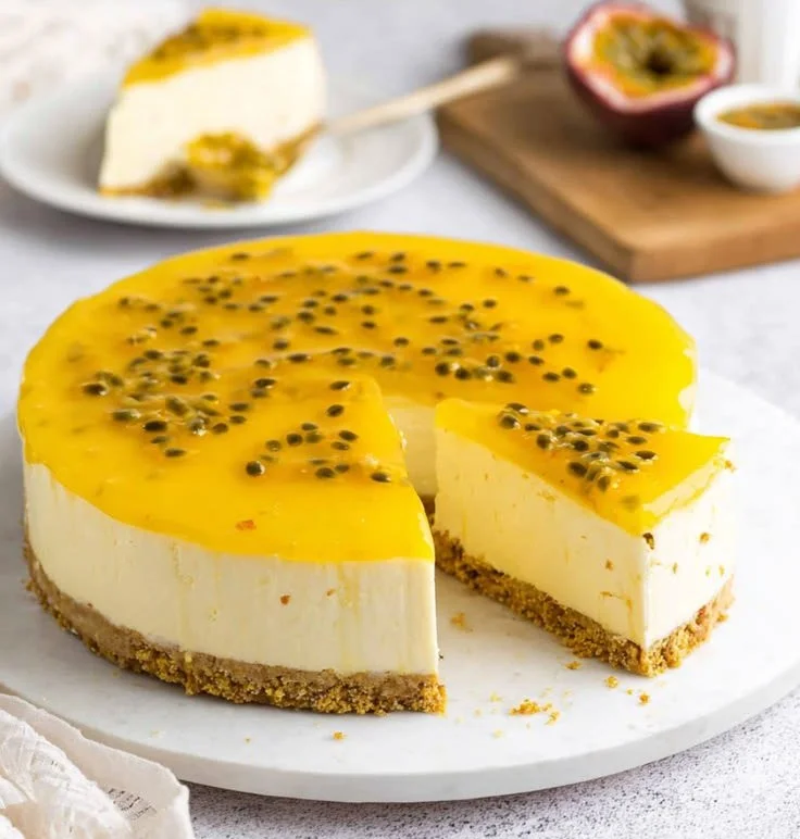 No bake passion fruit cheesecake topped with fresh passion fruit and whipped cream