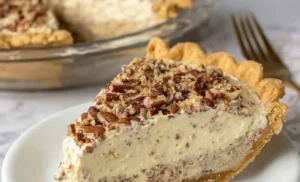 Slice of delicious pecan cream pie with whipped cream topping