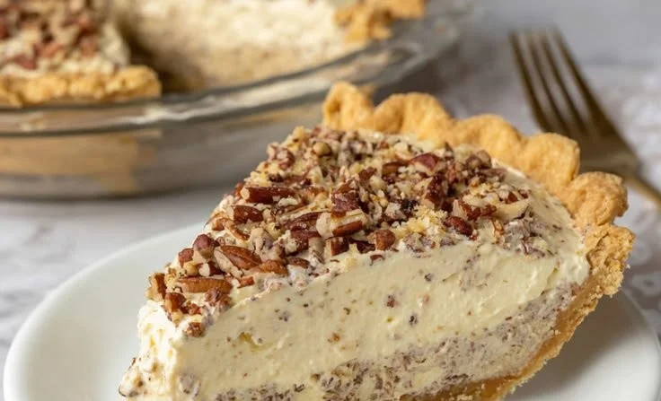 Slice of delicious pecan cream pie with whipped cream topping