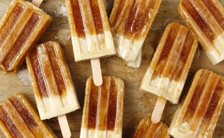 Delicious homemade Root Beer Popsicles melting in the sun