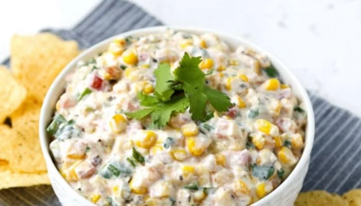 A bowl of skinny poolside dip served with fresh vegetables by the pool.
