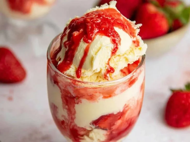 Delicious strawberry sundae topped with fresh strawberries and whipped cream