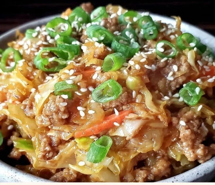 Healthy low-carb egg roll in a bowl dish with colorful vegetables and pork