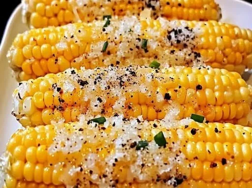 Delicious Parmesan Chive Corn on the Cob garnished with chives