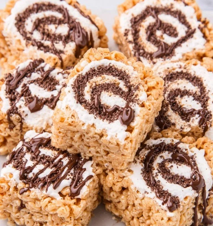 Rolled S'mores Rice Krispie Treats with chocolate, marshmallows, and graham crackers
