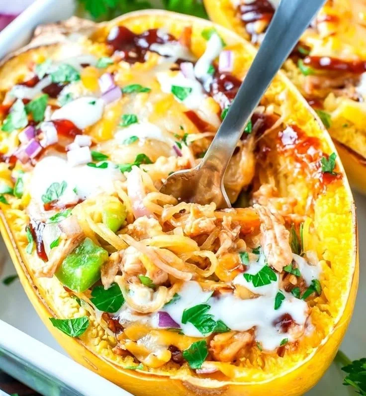 BBQ Chicken Spaghetti Squash dish garnished with herbs