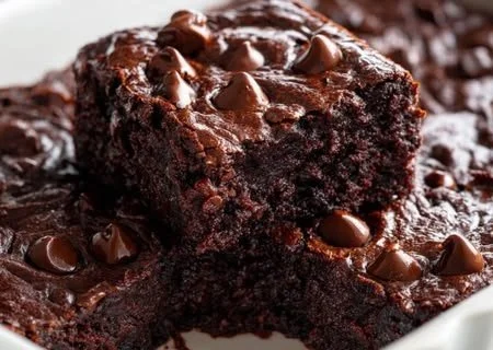 Delicious chocolate zucchini brownies on a plate, showcasing their rich texture.