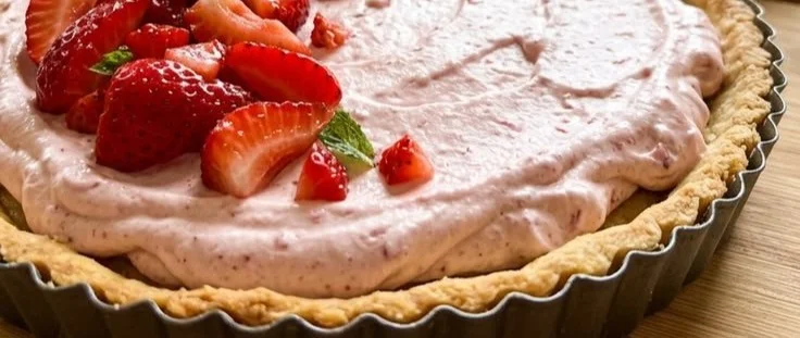 A delicious strawberry tart with fresh berries on a flaky crust.