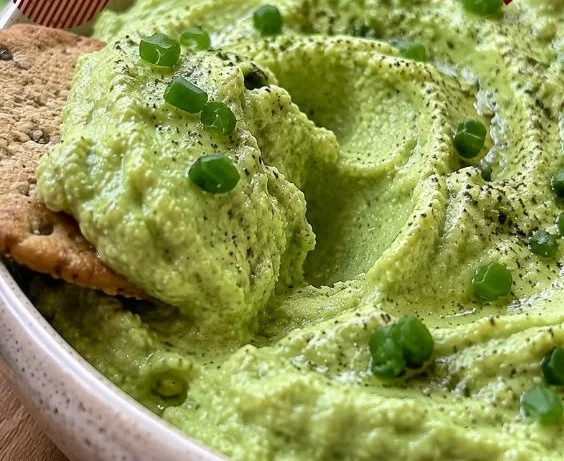 Whipped avocado cottage cheese dip served in a bowl with fresh veggies