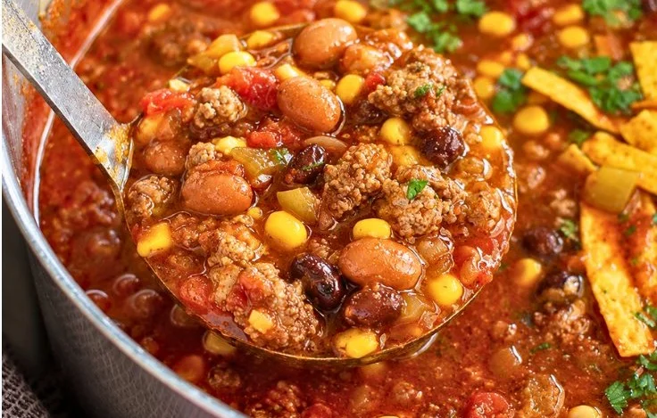 Bowl of delicious taco soup topped with cheese and cilantro