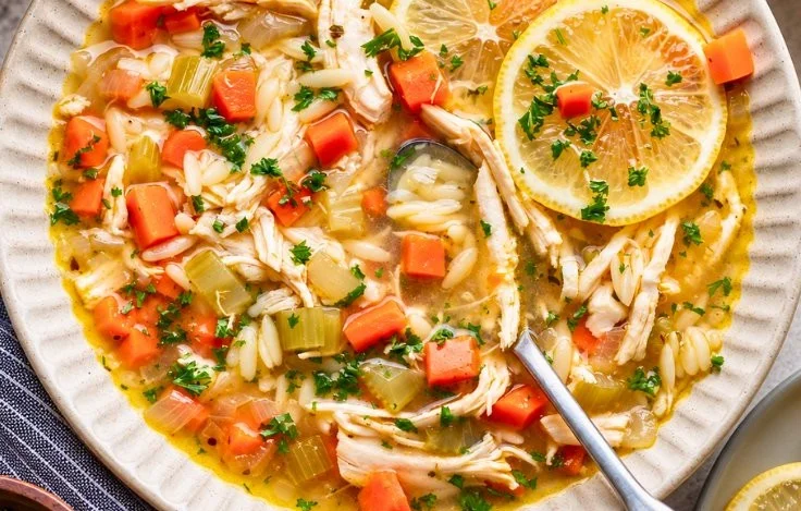 Bowl of Healthy Lemon Chicken Soup with Orzo served for a cozy dinner