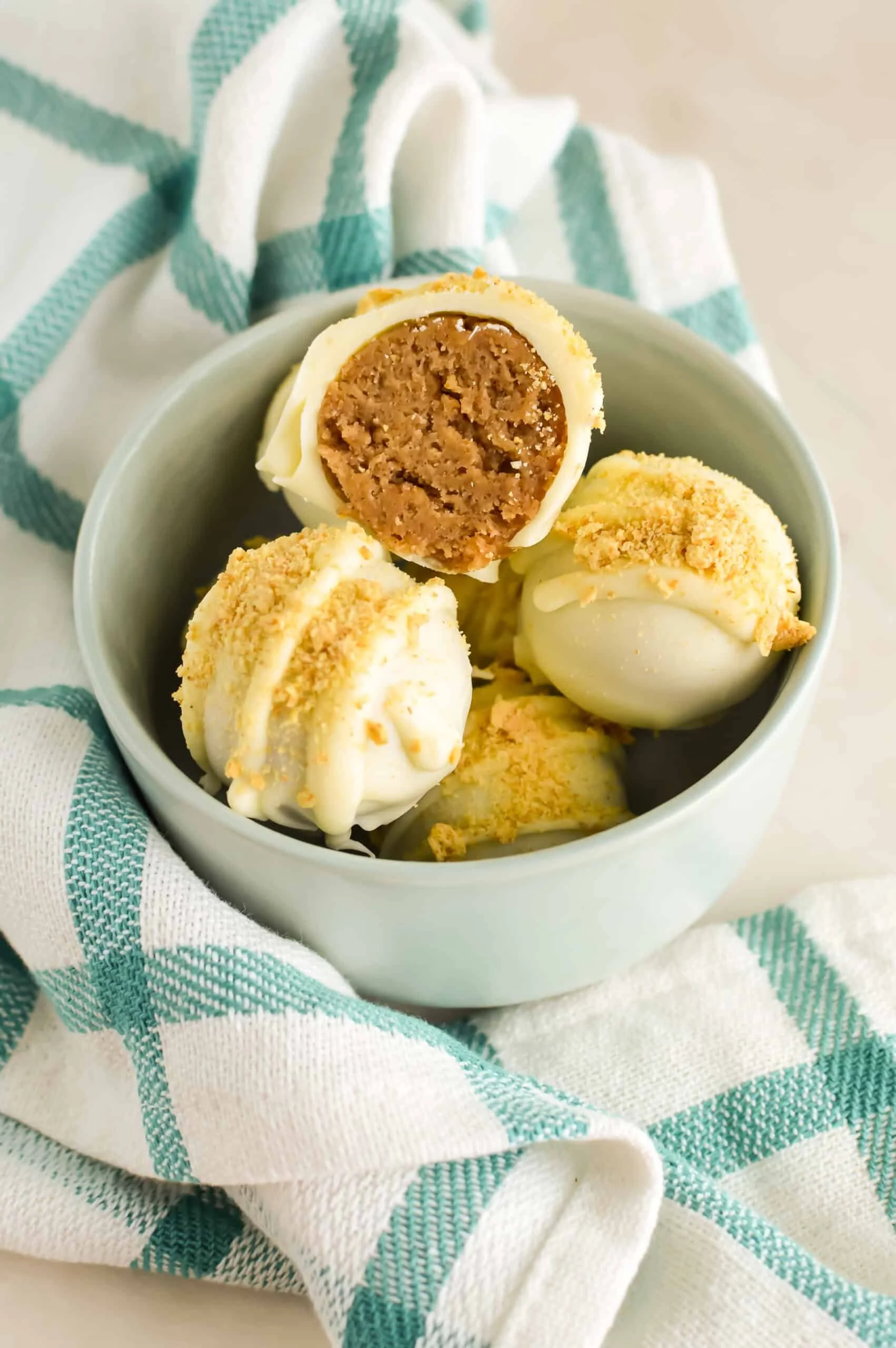 No-bake pumpkin pie cheesecake truffles on a decorative plate with fall leaves