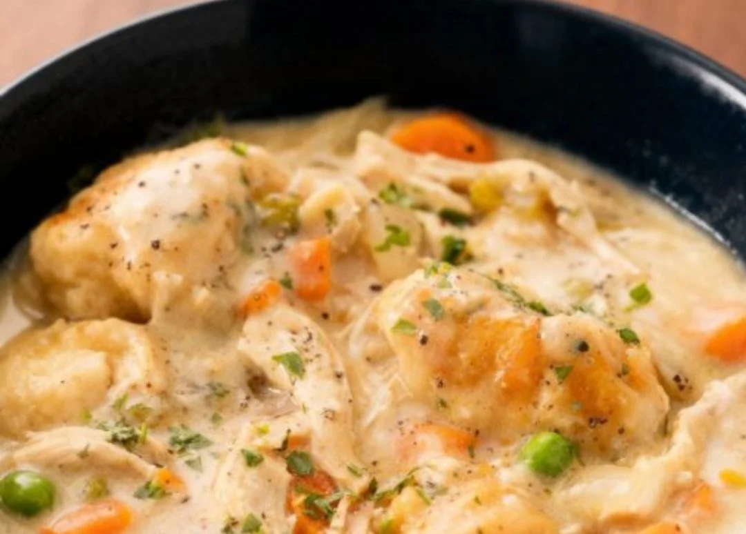 Slow cooker chicken and dumplings in a creamy broth with vegetables.